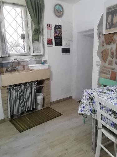 a small kitchen with a sink and a table at Casa vacanza La Mia Casetta Sutri Centro Storico in Sutri