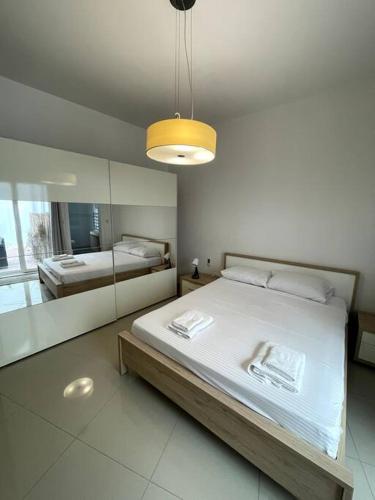 a bedroom with two beds and a large mirror at Swieqi : Central 3-Bed Apartment in Is-Swieqi