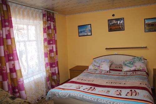 Ένα ή περισσότερα κρεβάτια σε δωμάτιο στο Guest House on Derbisheva
