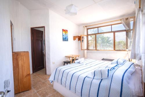Postel nebo postele na pokoji v ubytování Hostal Galapagos by Bar de Beto