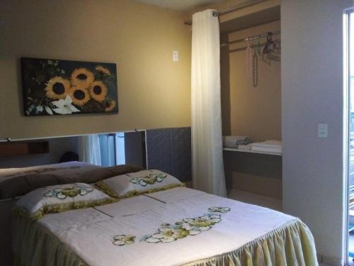 a bedroom with a bed with flowers on it at Apto 349 Terceira avenida Multishoping Centro Nucleo Bandeirante in Brasilia
