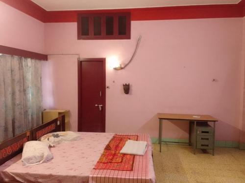 a bedroom with a bed and a table and a door at lotus Abode in Salem