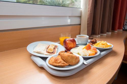 a tray of breakfast foods on a table at ibis Asuncion in Asuncion