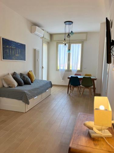 a bedroom with a bed and a dining room at Appartamento da Francesca in Casalecchio di Reno