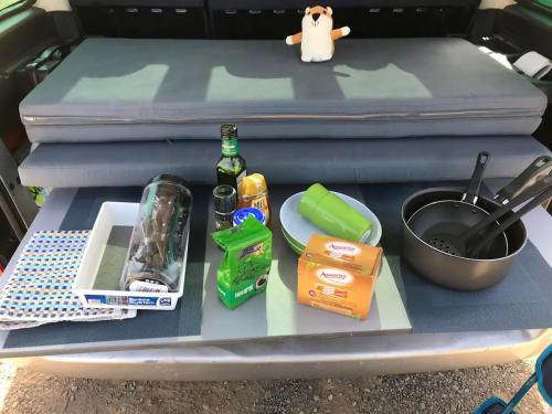 a lunch tray in the back of a car with a suitcase at CamperTF - old but lovable mini caravans in Tenerife in El Médano