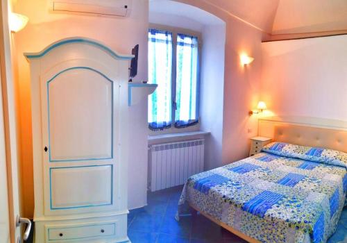 a bedroom with a bed and a dresser and window at Casa Vacanze La Rosa Del Mare in Amalfi