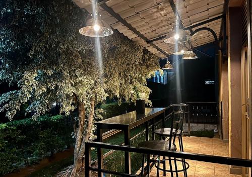 a patio with a table and chairs under a tree at Cosy Hidden Gem in Kigali