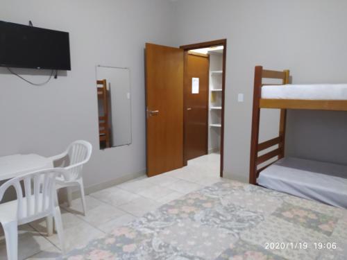 Ένα ή περισσότερα κρεβάτια σε δωμάτιο στο Pousada Recanto Vô Fredo