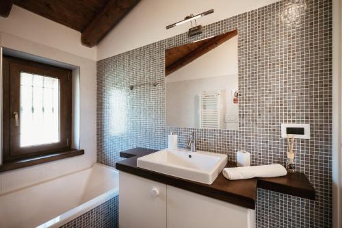 a bathroom with a sink and a mirror at Villa Gramolina Nizza in Nizza Monferrato