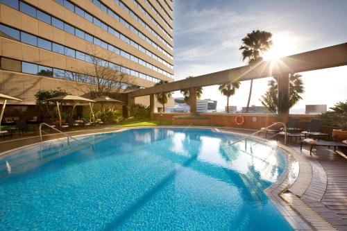 a large swimming pool in front of a building at Sandton Sun and Towers in Johannesburg