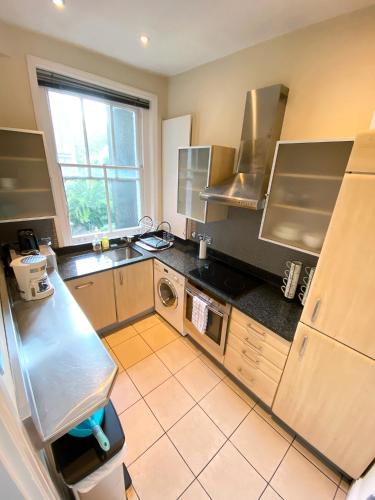 a small kitchen with a sink and a window at 3-Bedroom Flat Central London, 6 Min Walk from King's Cross Station in London
