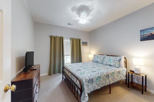 a bedroom with a bed and a flat screen tv at Legends Resort @ Myrtle Beach in Myrtle Beach