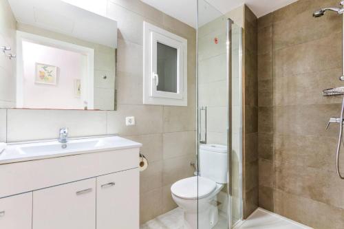 a bathroom with a toilet and a sink and a shower at Playamar in Alcudia
