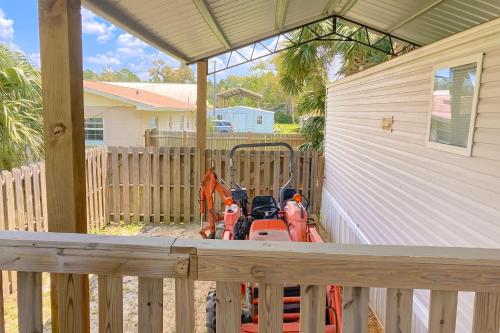 a lawn mower sitting on the porch of a house at Ms. Sara's Hideaway in Highland View