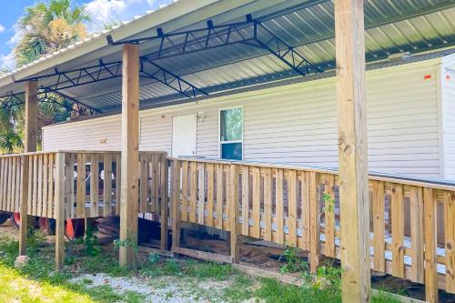 a house with a wooden porch with a pergola at Ms. Sara's Hideaway in Highland View