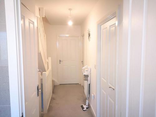 a hallway with a white door in a room at Harrow Home in Harrow
