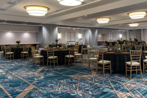 a ballroom with tables and chairs in a room at Hyatt Place St Augustine Vilano Beach in Saint Augustine