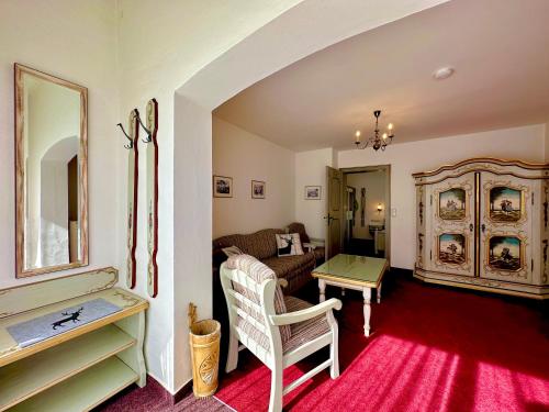 a living room with a couch and a table at Hotel Bergland in Grainau