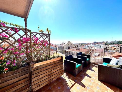 a balcony with chairs and a view of a city at Eddie Rooftop Lisbon center in Lisbon