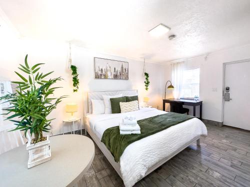 a bedroom with a large white bed with two tables at King Suite Apt With Shared Pool 02 in Clearwater