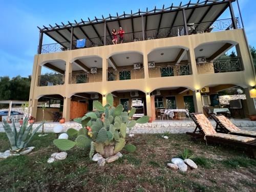 a building with people on the balcony of it at La Casa D' Irene in Agios Nikitas