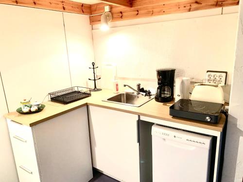 a small kitchen with a sink and a microwave at Villa Win in Lappeenranta