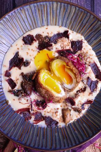 a plate of food with an egg on top at Hôtel & Restaurant des Remparts in Rochefort
