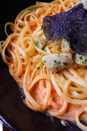 a plate of pasta with meat and cheese on it at Hôtel & Restaurant des Remparts in Rochefort