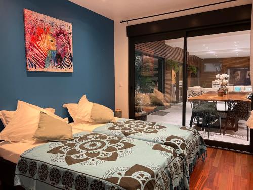 a bedroom with a bed with a painting on the wall at Villa Lou Santen Guadeloupe in Saint-François