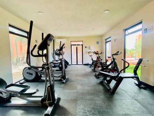 a gym with several treadmills and bikes in it at TriBeCa San Miguel in San Miguel de Allende