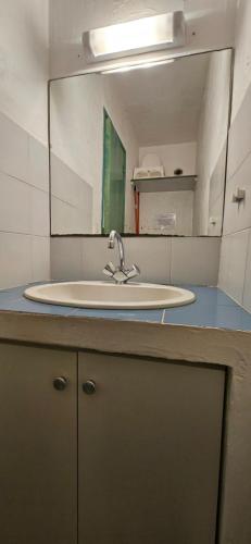 a bathroom with a sink and a mirror at ST CYPRIEN C18 -4/6 pers- CLIM- à 250m de la plage de sable Saint Cyprien in Lecci