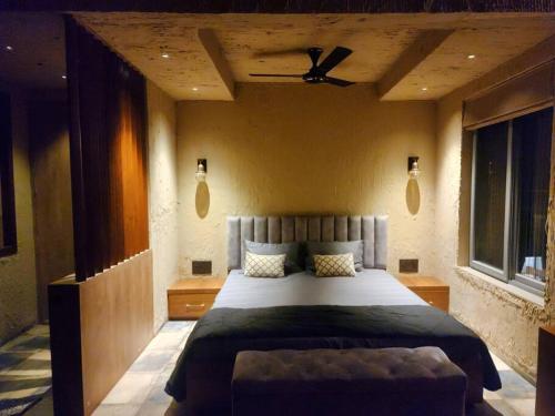 a bedroom with a large bed with a ceiling at Revanta Studio Flat in Kolhapur