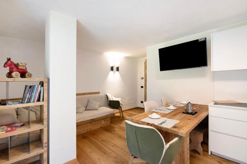 a kitchen and living room with a table and a couch at Valgrisa Mountain Lodges 3 in Valgrisenche