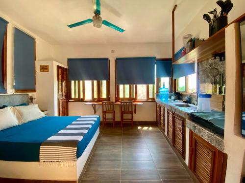 a bedroom with a bed and a kitchen with a sink at MINI DEPARTAMENTO con vista al mar in San Agustinillo