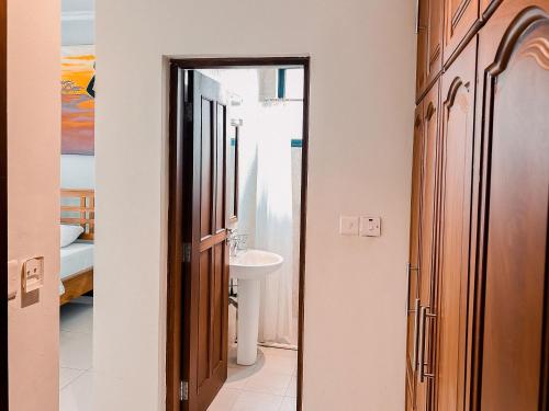 a bathroom with a sink and a toilet in a room at Elles Residence in Dar es Salaam