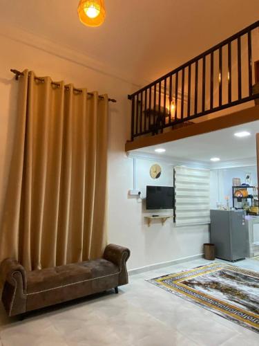 a living room with a brown curtain and a couch at Abe.Cottage 3 in Kampong Chawat