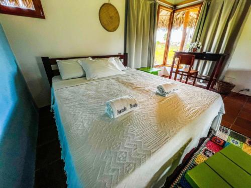a bedroom with a bed with two towels on it at Pousada Theodora in Macapá