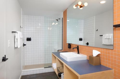 a bathroom with a sink and a shower at Rhode's Motor Lodge in Boone