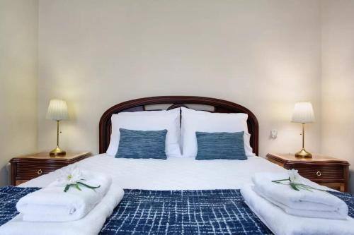 a bedroom with a large bed with two night stands at Central Living Funchal in Funchal