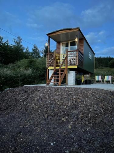 a small house with a staircase in front of it at The Haycart in Tobar Pheadair