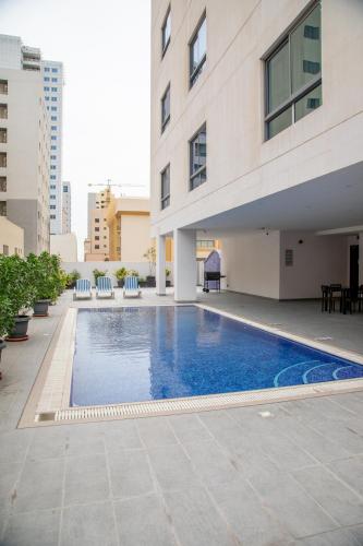 a swimming pool in the middle of a building at The Apple Residence in Juffair