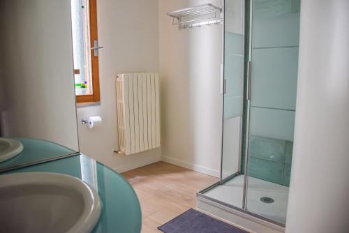 a bathroom with a sink and a glass shower at [Duomo Luxury Home * * * * *] San Paolo Cathedral in Treviso
