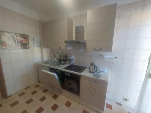 a small kitchen with a sink and a stove at AGLIANO LOVELY APARTMENT in Agliano Terme