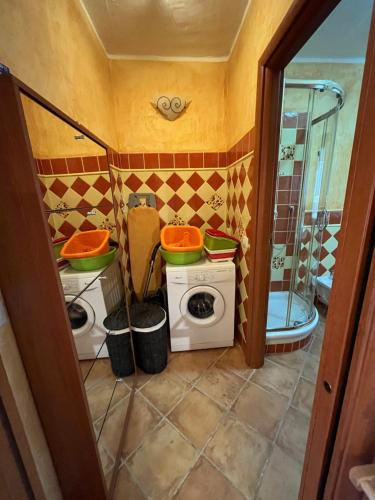 a bathroom with two toilets and a shower at La Casa sulla collina "Baccu e Idda" in Chia