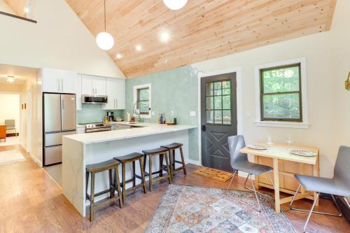 a kitchen with a counter and chairs and a table at Community Beach Access Modern Poconos Cabin! in Albrightsville