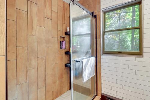 a shower with a glass door in a bathroom at Community Beach Access Modern Poconos Cabin! in Albrightsville