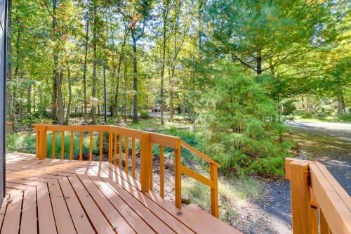 a wooden bench sitting on top of a wooden deck at Community Beach Access Modern Poconos Cabin! in Albrightsville