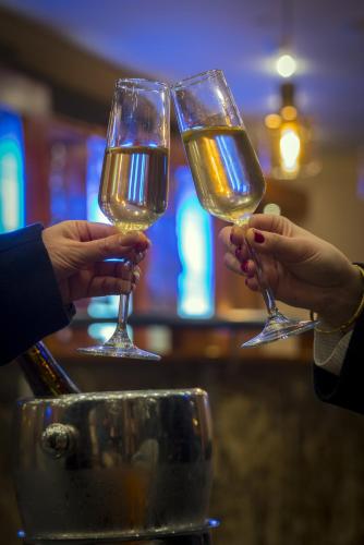 two people holding up glasses of wine at Park Lake Luxury Hotel in Pucón