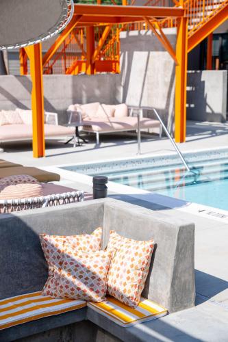 two pillows sitting on a bench next to a pool at The Myriad Hotel Louisville, Tapestry Collection by Hilton in Louisville