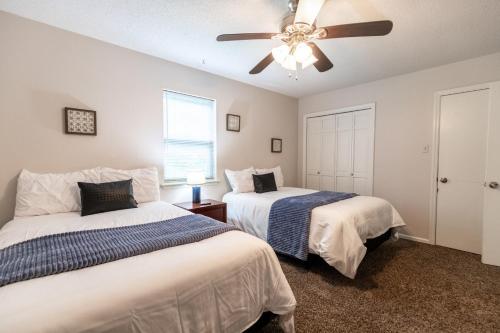 a bedroom with two beds and a ceiling fan at Allwood Cottage 1 in North Little Rock